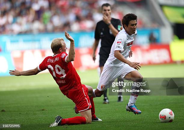 Ja-Cheol Koo of FCA competes for the ball with Tobias Levels of Fortuna during the Bundesliga match between FC Augsburg and Fortuna Duesseldorf 1895...