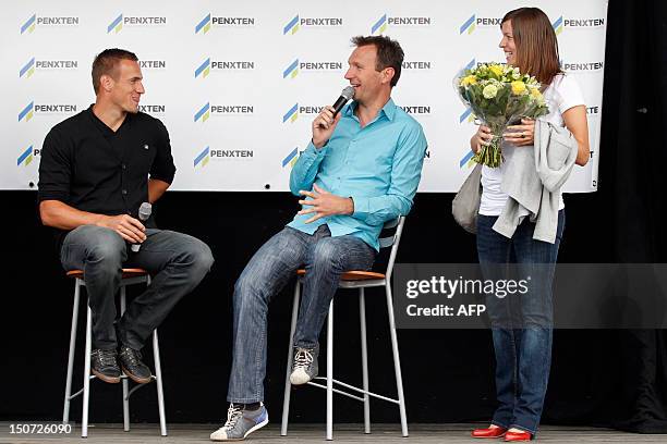 Belgium's decathlon athlete Hans Van Alphen , Flemish journalist Stef Wijnants and Van Alphen's partner Kim , speak during a celebration for Hans Van...