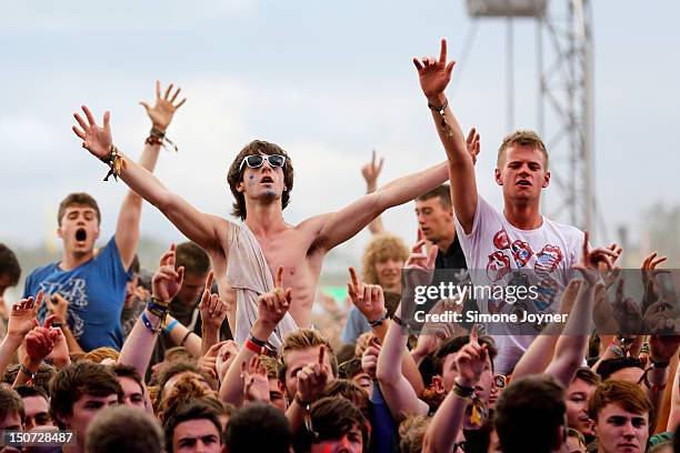 Fans soak up the atmopshere as Enter Shikari perform live on the Main Stage on Day Two during the Reading Festival 2012 at Richfield Avenue on August...