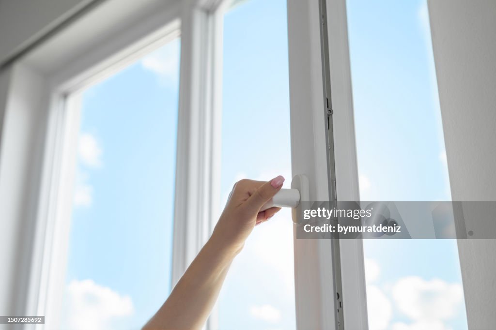Woman opening window