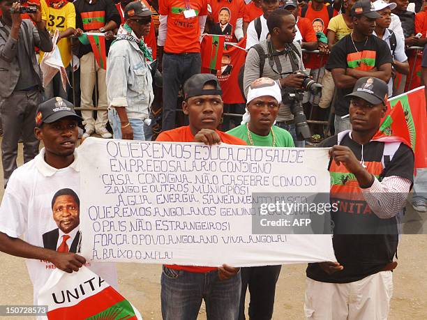 Unita activists hold up a banner during a protest in the center of Luanda on August 25, 2012 to ask for free and fair elections. Angola's main...