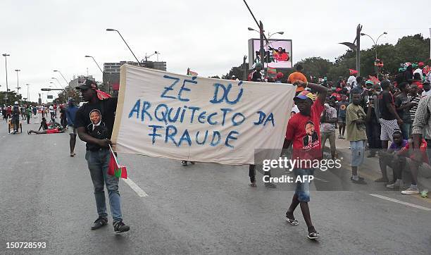 Unita activists hold a banner during a protest in the center of Luanda on August 25, 2012 to ask for free and fair elections. Angola's main...