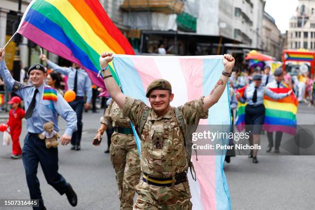 Member of the British Army carries a transgender flag during the Gay Pride Parade on July 01, 2023 in London, England. Pride in London is an annual...