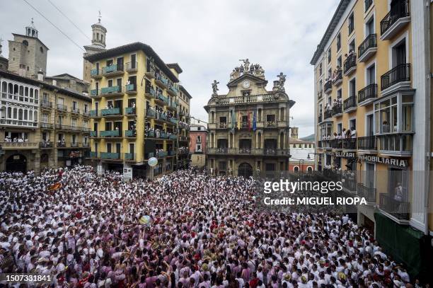 Participants gather before the "Chupinazo" opening ceremony to mark the kick-off of the San Fermin bull Festival outside the Town Hall of Pamplona in...