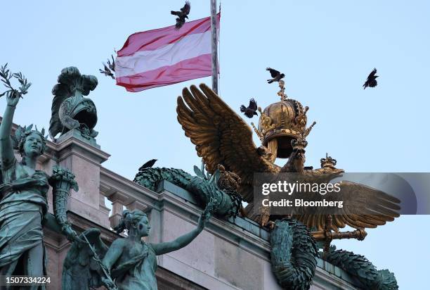 An Austrian flag above the entrance to the Hofburg Palace during the 8th OPEC International Seminar in Vienna, Austria, on Wednesday, July 5, 2023....