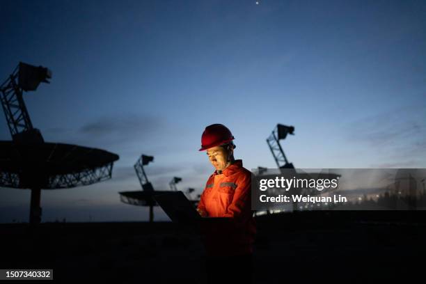 engineer in hard hat working with laptop. - telecom stock pictures, royalty-free photos & images