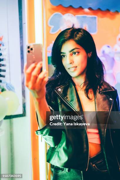 a beautiful asian woman using mobile phone - fashion icon ai stock-fotos und bilder