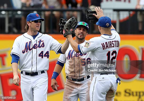 Jason Bay, Andres Torres and Scott Hairston of the New York Mets celebrate after defeating the Houston Astros at Citi Field on August 25, 2012 in the...