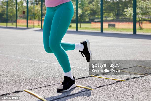 a woman working out in her local park using an agility ladder - close up - human muscle stock pictures, royalty-free photos & images