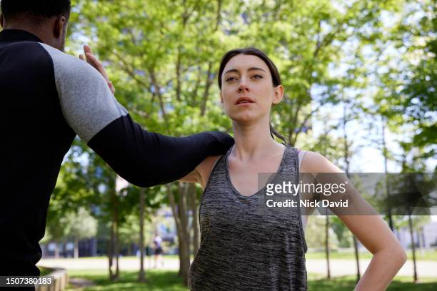 a man and women fitness training together in their local city park - human muscle stock pictures, royalty-free photos & images