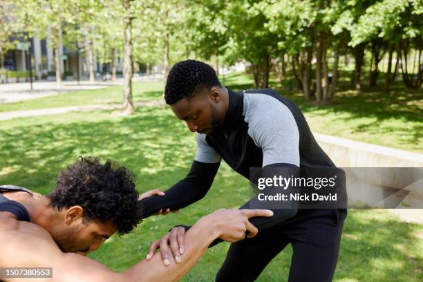 two men fitness training together at their local park - human muscle stock pictures, royalty-free photos & images