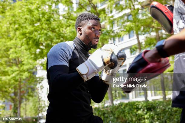 a man boxing training with his fitness instructor outside in a city park - human muscle stock pictures, royalty-free photos & images