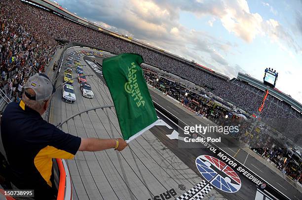 Casey Mears, driver of the GEICO Ford, and Brad Keselowski, driver of the Miller Lite Dodge, lead the field to the green flag to start the NASCAR...