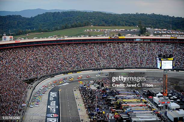 Casey Mears, driver of the GEICO Ford, and Brad Keselowski, driver of the Miller Lite Dodge, lead the field to the green flag to start the NASCAR...