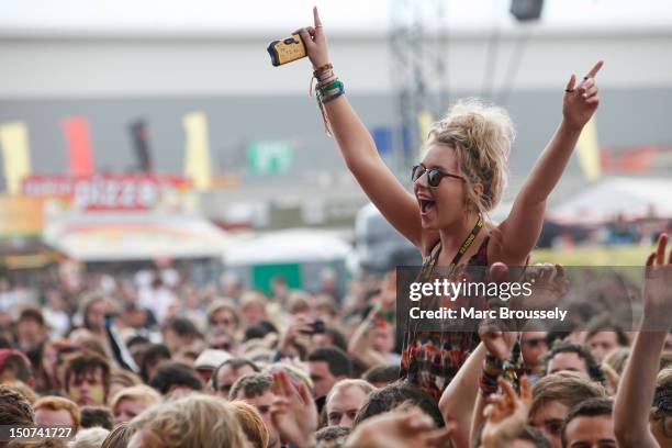 Fans enjoying the performance of Enter Shikari on the main stage during Day 2 of Reading Festival at Richfield Avenue on August 25, 2012 in Reading,...