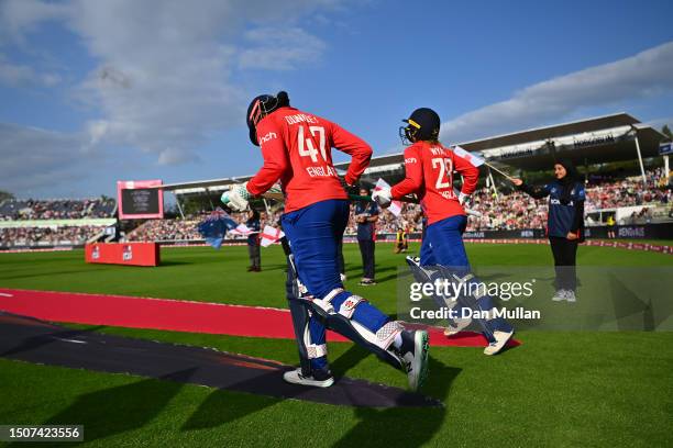 Sophia Dunley and Danni Wyatt of England make their way out to open the batting during the Women's Ashes 1st Vitality IT20 match between England and...