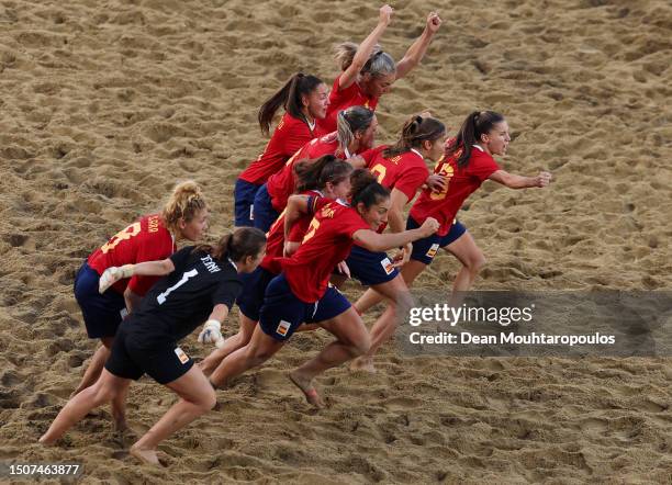 Players of Spain celebrate victory in the penalty shoot out in the Beach Soccer - Women's Gold Medal Match between Ukraine and Spain on Day Twelve of...