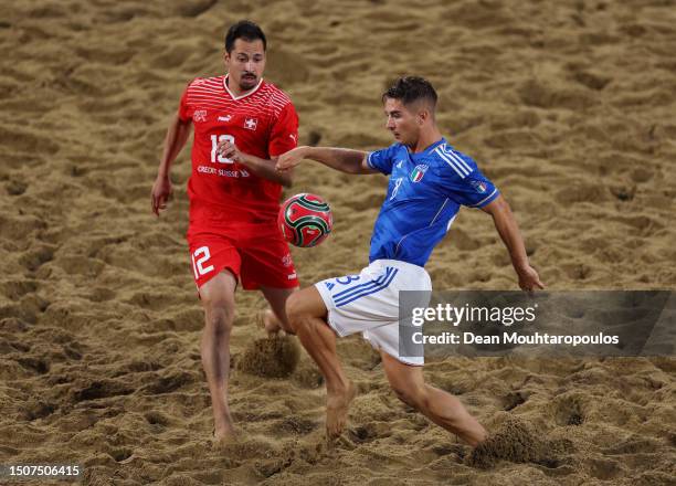 Tommaso Fazzini of Italy controls the ball whilst under pressure from Patrick Ruettimann of Switzerland during the Beach Soccer - Men's Gold Medal...