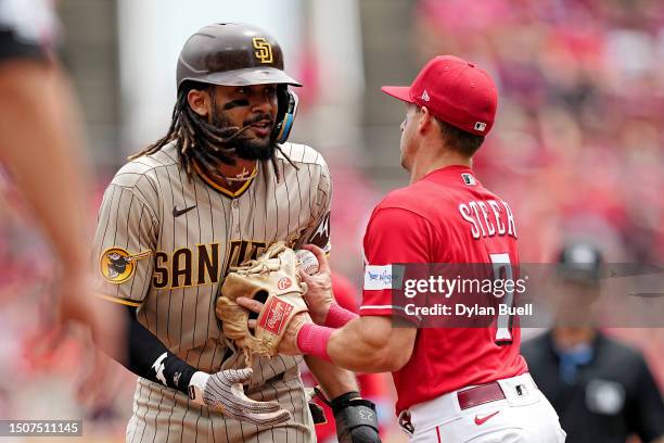 Spencer Steer of the Cincinnati Reds tags out Fernando Tatis Jr. #23 of the San Diego Padres during a rundown in the third inning at Great American...