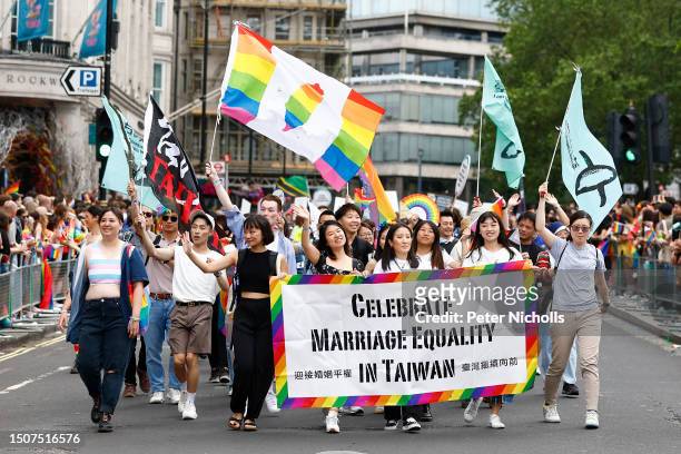 Celebrate Marriage Equality in Taiwan take part in the parade on July 01, 2023 in London, England. Pride in London is an annual LGBT+ festival and...