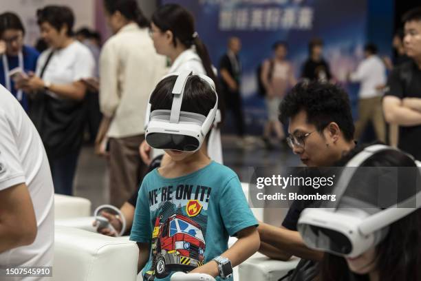 Attendees try on virtual reality headsets at the World Artificial Intelligence Conference in Shanghai, China, on Thursday, July 6, 2023. The...