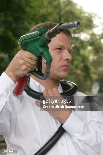 Man with the hose of a nozzle round his neck.