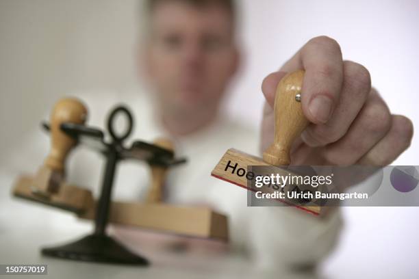 Bonn, Man holding Hoechst AG stamp.