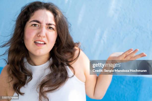 young woman making a face looking uncertain, confused, perplexed, wtf - wtf expression stock pictures, royalty-free photos & images