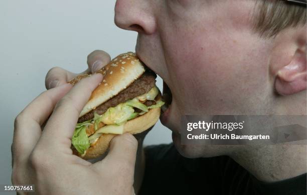 Man eating a hamburger .