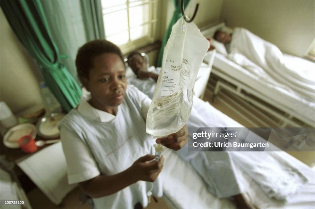 SOUTH AFRICA, MARIANNHILL, An African nurse adjusts the intravenous drip of the infusion of a patient in a hospital room in St, Marys Hospital in Mariannhill near Durban.