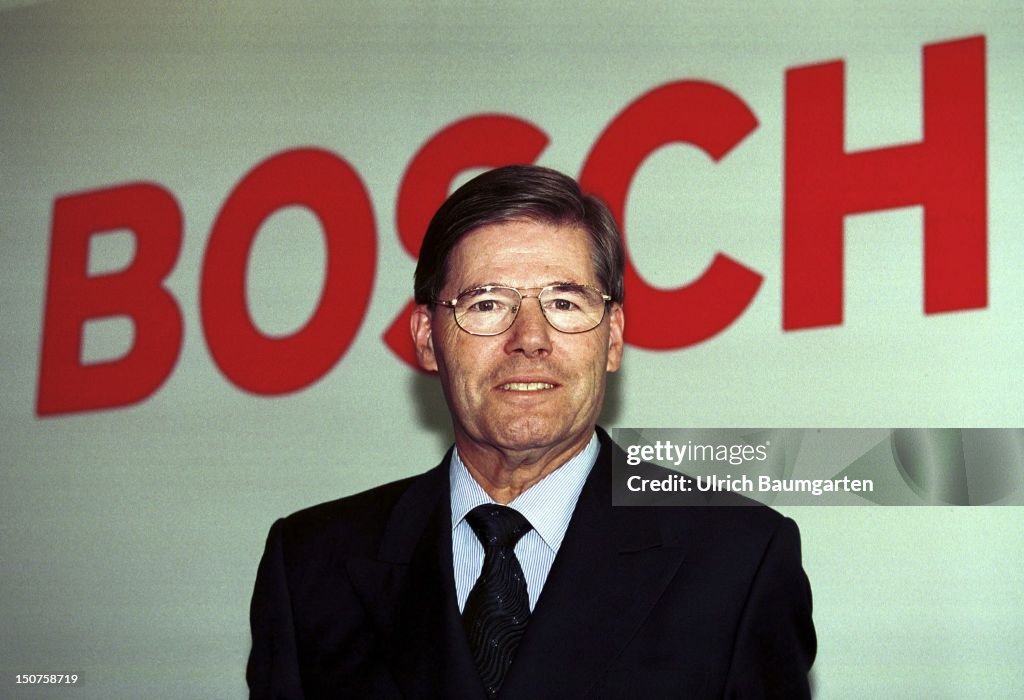 Hermann SCHOLL, chairman of the management of the Bosch AG, in front of the Bosch logo.