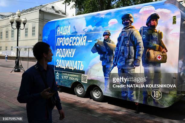 Man walks past a contract army service mobile recruitment point in Moscow on July 6, 2023.