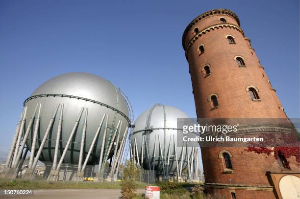 Gas storage tanks of the Berliner Gaswerke AG with a historic water tower.