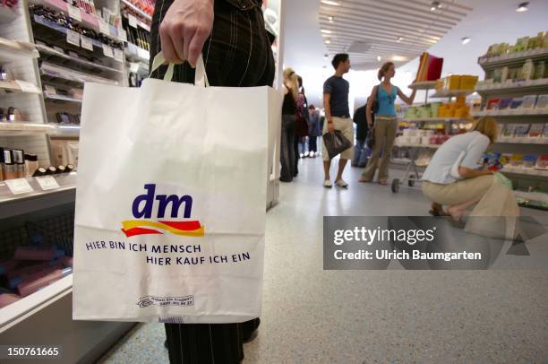 Customers in a dm chemist's shop.