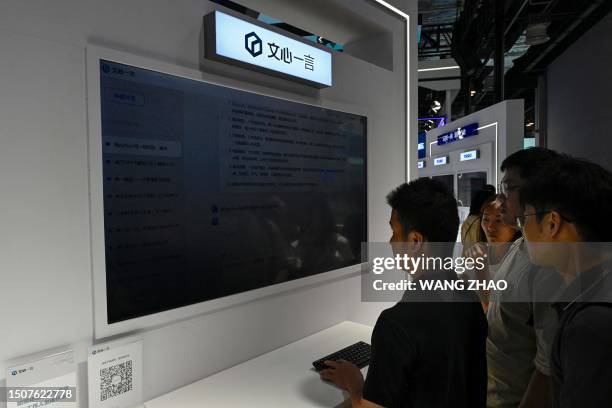 People examine an AI product of Baidu during the World Artificial Intelligence Conference in Shanghai on July 6, 2023.