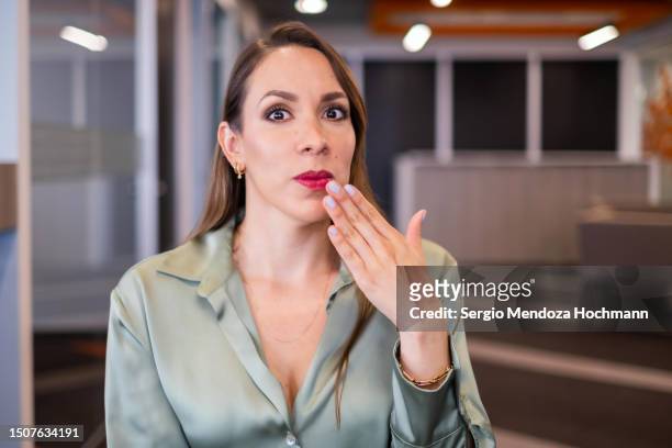 latina covering her mouth with an oops gesture, whoops, error, mistake, speak no evil - restrictions stock pictures, royalty-free photos & images