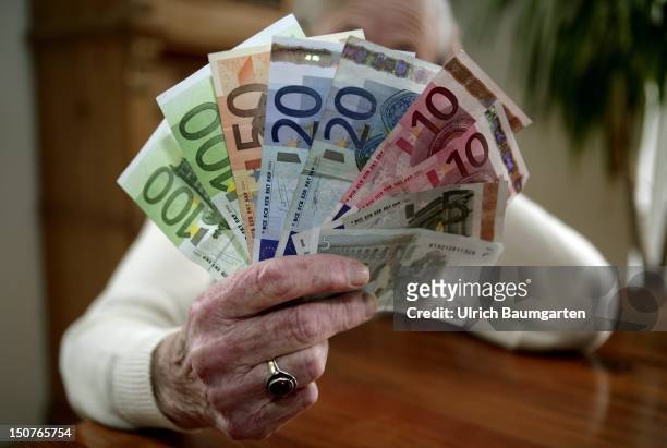 Female pensioner with Euro-banknotes.