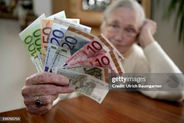 Female pensioner with Euro-banknotes.