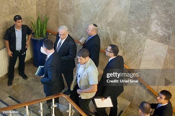 Israeli Prime Minister Benjamin Netanyahu speaks to Israeli education minister Gideon Saar as they arrive to the weekly cabinet meeting in his...