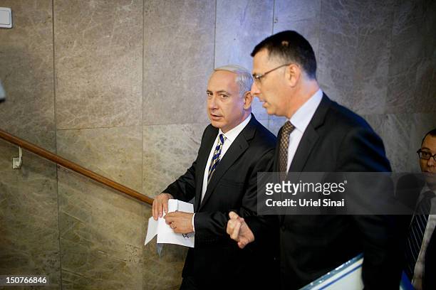 Israeli Prime Minister Benjamin Netanyahu speaks to Israeli education minister Gideon Saar as they arrive for the weekly cabinet meeting in his...