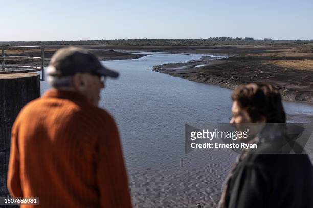 People look the Santa Lucia river at Paso Severino reservoir on July 01, 2023 in Florida, Uruguay. 'La Niña' climatic phenomenon has brought Uruguay...