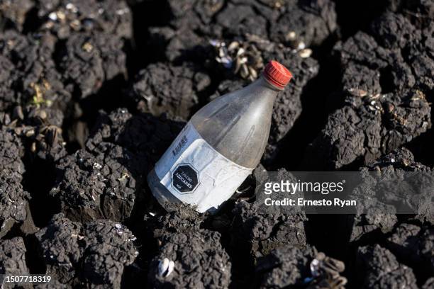 Plastic bottle is seen in a dry section of the Santa Lucia river at the Paso Severino reservoir on July 01, 2023 in Florida, Uruguay. 'La Niña'...