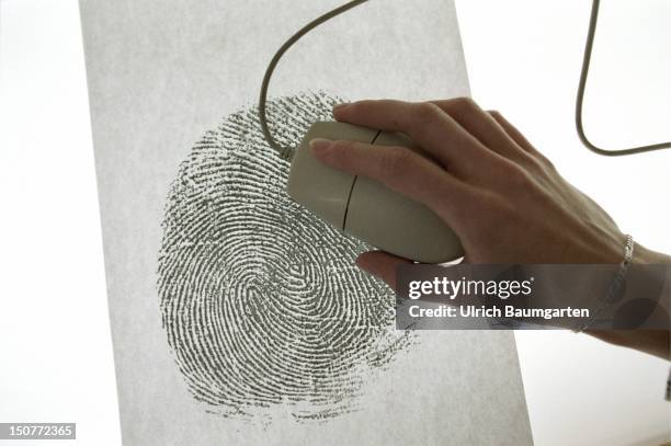 Hand with computer mouse and an oversized fingerprint, Symbol to the topics: computer crime, crime detection.
