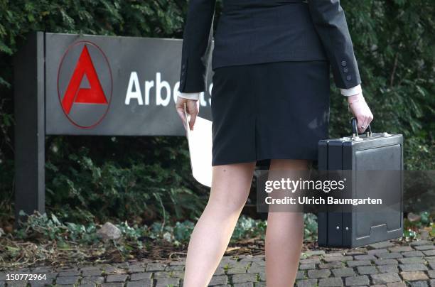 Qualified and unemployed, businesswoman infront sign of employment office.