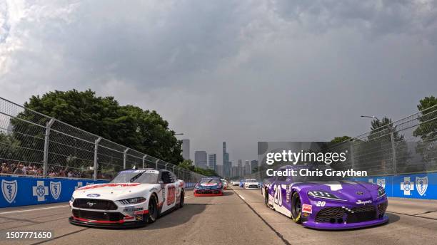 Cole Custer, driver of the HAAS Automation Ford, and John Hunter Nemechek, driver of the Yahoo Toyota, lead the field on a pace lap prior to the...