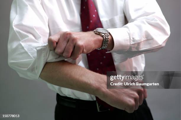 Businessman pulling up his sleeves.