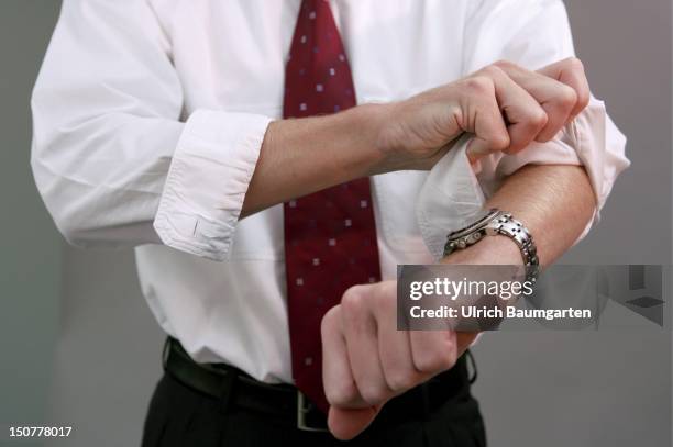 Businessman pulling up his sleeves.