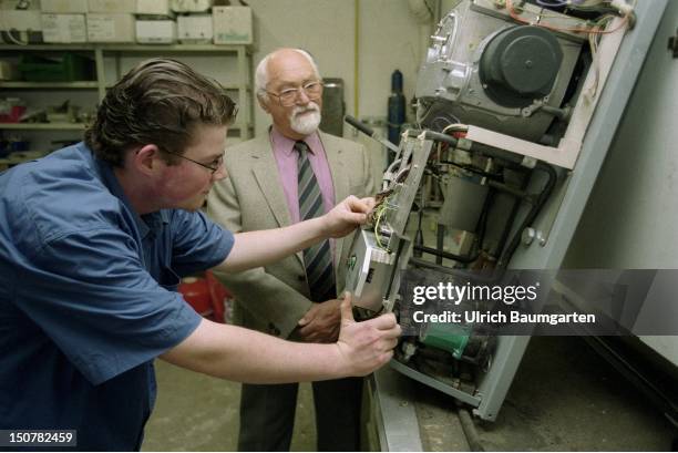 Master and trainee during training in a heating - sanitary firm.