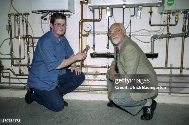 Master and trainee during training in a heating - sanitary firm.