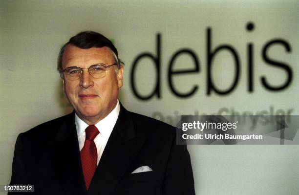 Klaus MANGOLD, chairman of the board of management of the DaimlerChrysler Services Plc, in front of the debis logo.